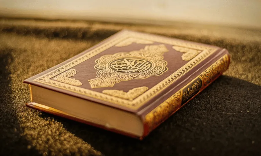 Quran placed on a prayer carpet