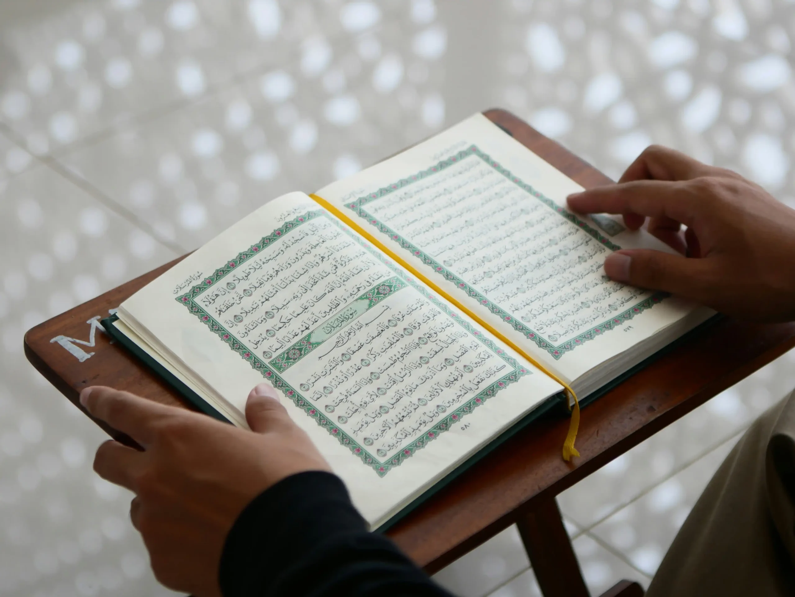 A learner following Quran text carefully during reading practice
